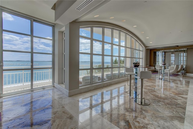808 Brickell Key Dr Unit 3007, Miami, FL 33131 - interior space featuring marble tiled flooring, a water view, healthy amount of natural light, and vaulted ceiling