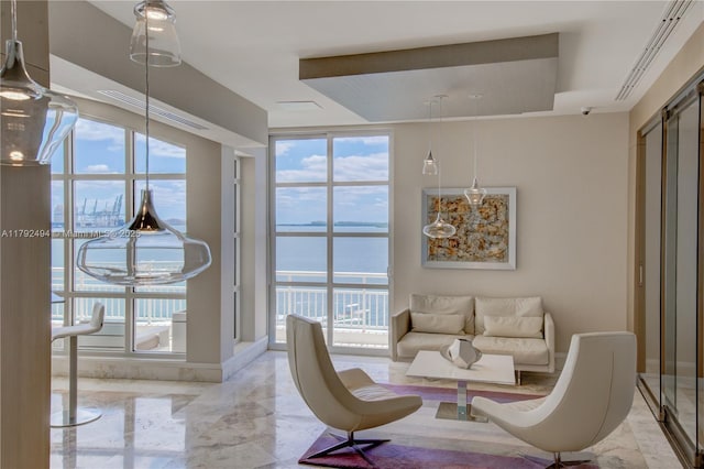 808 Brickell Key Dr Unit 3007, Miami, FL 33131 - living room featuring light marble finish floors, a water view, and expansive windows