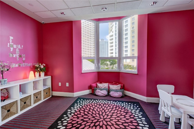 808 Brickell Key Dr Unit 3007, Miami, FL 33131 - rec room featuring baseboards, a paneled ceiling, carpet, and a view of city