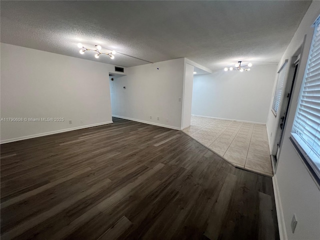 3089 E Yarmouth E Unit 3089, Boca Raton, FL 33434 - unfurnished room featuring wood finished floors, a chandelier, and a textured ceiling
