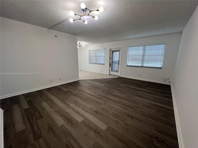 3089 E Yarmouth E Unit 3089, Boca Raton, FL 33434 - spare room with a chandelier, a textured ceiling, and dark wood-style floors