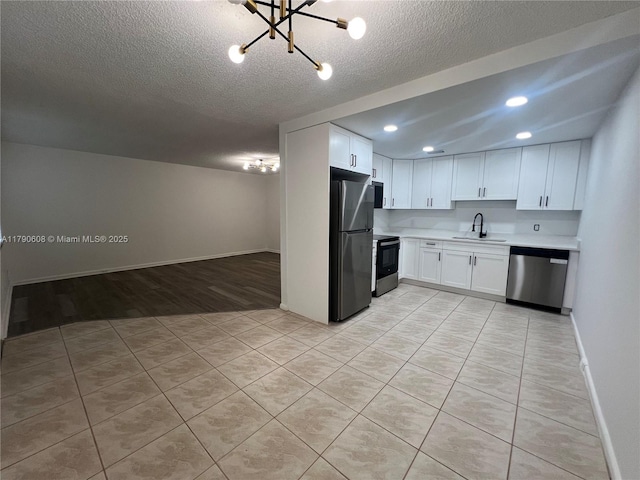 3089 E Yarmouth E Unit 3089, Boca Raton, FL 33434 - kitchen with stainless steel appliances, a chandelier, light countertops, white cabinetry, and open floor plan