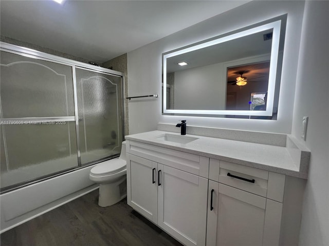 3089 E Yarmouth E Unit 3089, Boca Raton, FL 33434 - bathroom with vanity, enclosed tub / shower combo, wood finished floors, and a ceiling fan