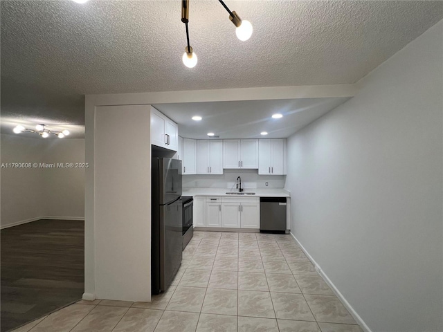 3089 E Yarmouth E Unit 3089, Boca Raton, FL 33434 - kitchen featuring stainless steel dishwasher, freestanding refrigerator, white cabinetry, light countertops, and electric range oven