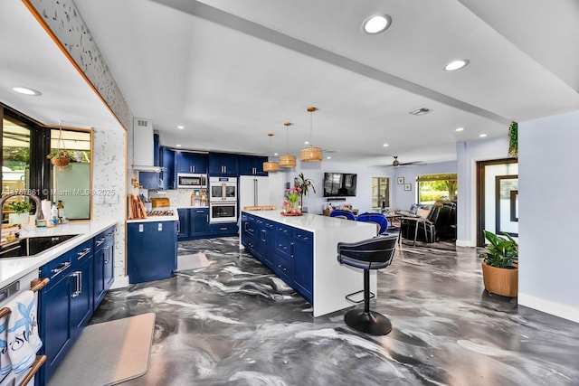 7864 SW 179th Ter, Palmetto Bay, FL 33157 - kitchen with a sink, light countertops, stainless steel microwave, white double oven, and blue cabinets