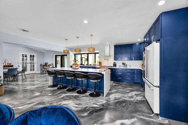 7864 SW 179th Ter, Palmetto Bay, FL 33157 - kitchen featuring high end fridge, light countertops, a kitchen breakfast bar, blue cabinetry, and visible vents