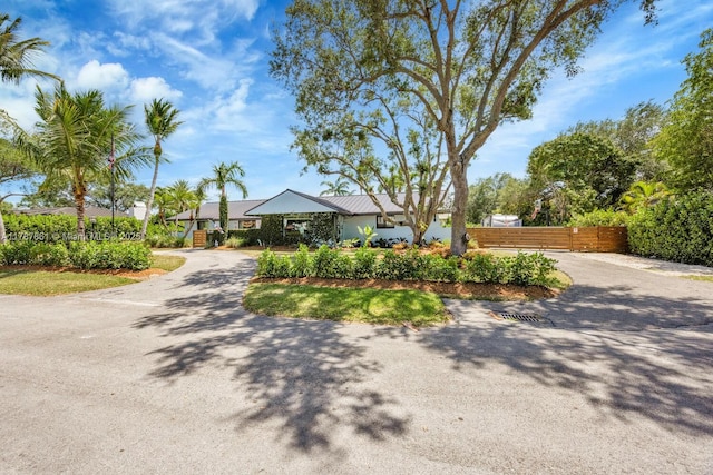 7864 SW 179th Ter, Palmetto Bay, FL 33157 - view of front of property with fence, driveway, and metal roof