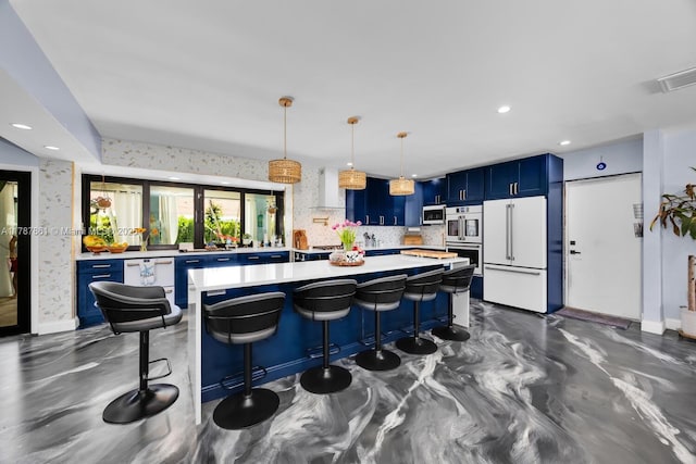 7864 SW 179th Ter, Palmetto Bay, FL 33157 - kitchen with blue cabinetry, light countertops, double oven, high end fridge, and wall chimney exhaust hood