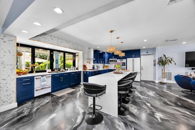 7864 SW 179th Ter, Palmetto Bay, FL 33157 - kitchen with visible vents, light countertops, wall chimney exhaust hood, blue cabinets, and stainless steel appliances