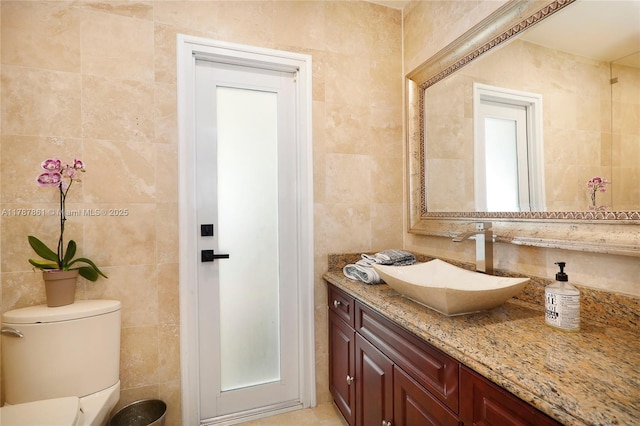 7864 SW 179th Ter, Palmetto Bay, FL 33157 - bathroom featuring tile walls, vanity, and toilet