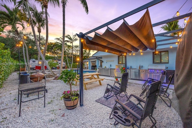 7864 SW 179th Ter, Palmetto Bay, FL 33157 - patio terrace at dusk with a gazebo, a grill, and exterior kitchen