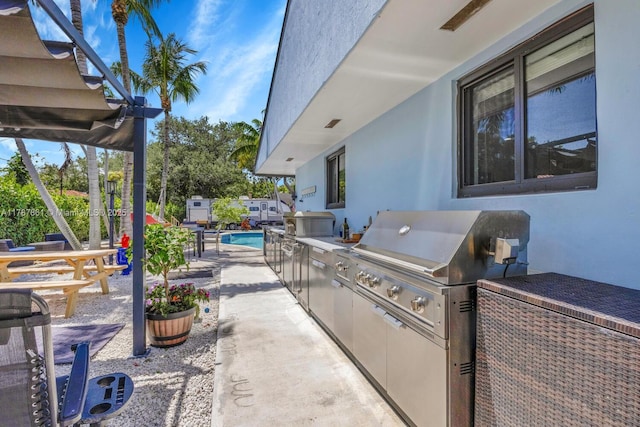 7864 SW 179th Ter, Palmetto Bay, FL 33157 - view of patio / terrace with a grill, an outdoor pool, and an outdoor kitchen