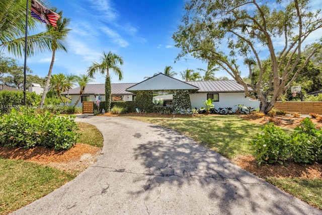 7864 SW 179th Ter, Palmetto Bay, FL 33157 - ranch-style house featuring fence, driveway, a front yard, and metal roof