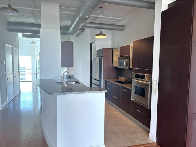 3029 NE 188th St Unit 905, Aventura, FL 33180 - kitchen with appliances with stainless steel finishes, a high ceiling, modern cabinets, stone countertops, and pendant lighting