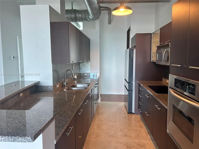 3029 NE 188th St Unit 905, Aventura, FL 33180 - kitchen featuring stainless steel appliances, modern cabinets, dark stone counters, and a towering ceiling
