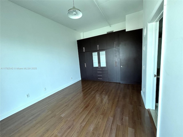 3029 NE 188th St Unit 905, Aventura, FL 33180 - spare room featuring dark wood-type flooring and baseboards