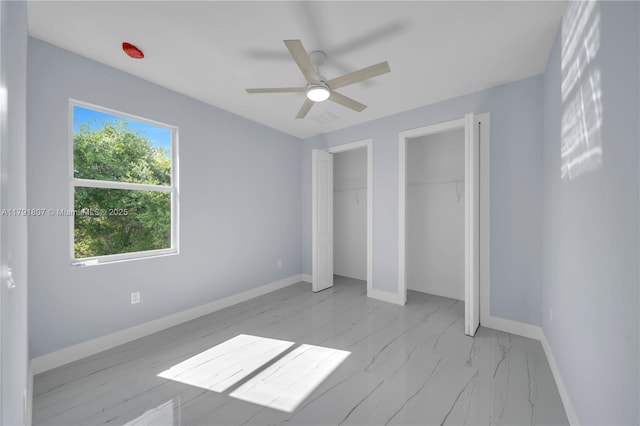 516 Millcreek St, Lehigh Acres, FL 33974 - unfurnished bedroom featuring a ceiling fan, baseboards, multiple closets, and marble finish floor