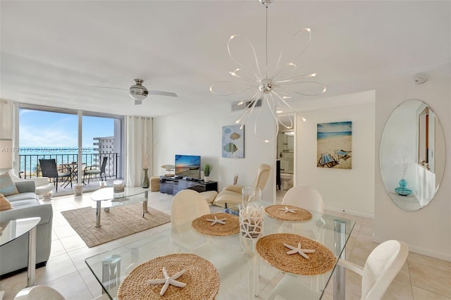 dining area with visible vents, baseboards, floor to ceiling windows, light tile patterned floors, and a notable chandelier