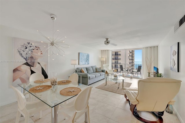living room with visible vents, ceiling fan with notable chandelier, and light tile patterned flooring
