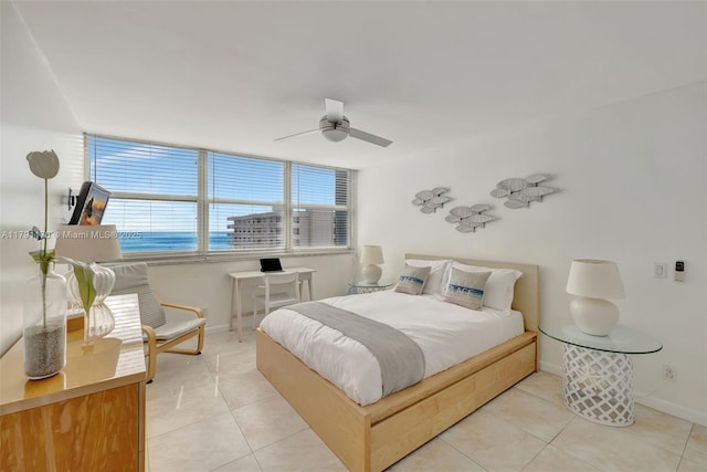 bedroom with baseboards, a ceiling fan, and light tile patterned floors