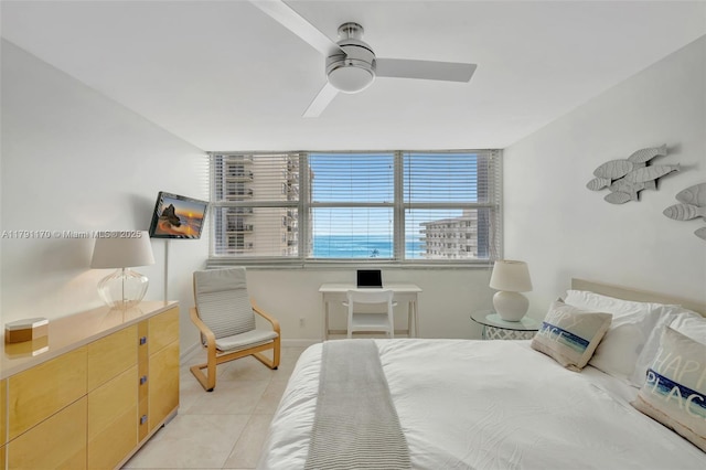 bedroom featuring light tile patterned floors, baseboards, and a ceiling fan
