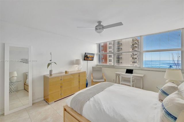 bedroom with a ceiling fan and light tile patterned flooring