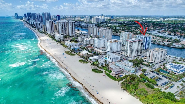 birds eye view of property with a water view, a view of city, and a view of the beach