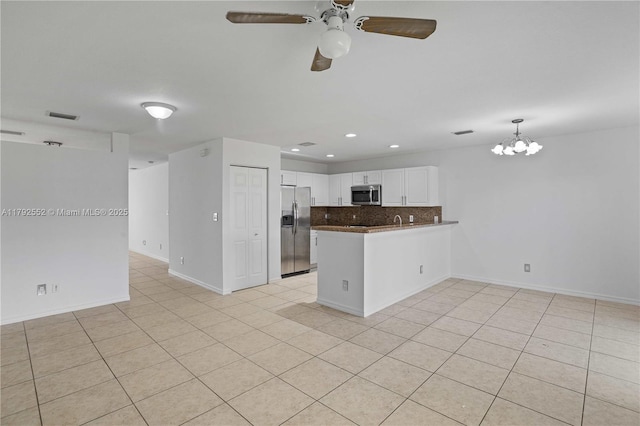 330 SW 2nd Ave Unit 3, Hallandale Beach, FL 33009 - kitchen featuring decorative backsplash, a peninsula, open floor plan, appliances with stainless steel finishes, and light tile patterned floors