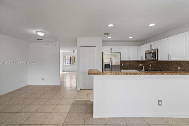 330 SW 2nd Ave Unit 3, Hallandale Beach, FL 33009 - kitchen featuring visible vents, a peninsula, appliances with stainless steel finishes, and white cabinets