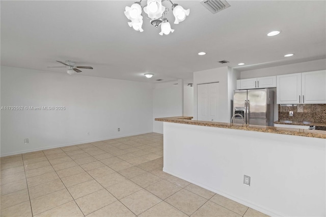 330 SW 2nd Ave Unit 3, Hallandale Beach, FL 33009 - kitchen with white cabinets, stainless steel fridge, ceiling fan with notable chandelier, recessed lighting, and visible vents