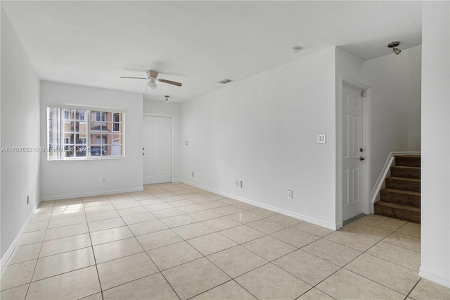 330 SW 2nd Ave Unit 3, Hallandale Beach, FL 33009 - unfurnished room with light tile patterned floors, baseboards, ceiling fan, and stairs