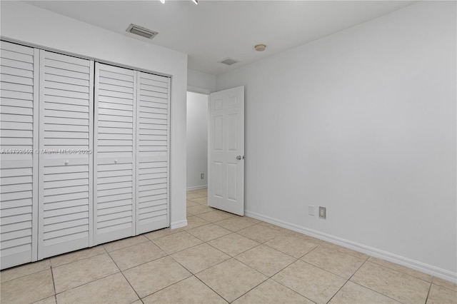330 SW 2nd Ave Unit 3, Hallandale Beach, FL 33009 - unfurnished bedroom featuring baseboards, visible vents, light tile patterned floors, and a closet