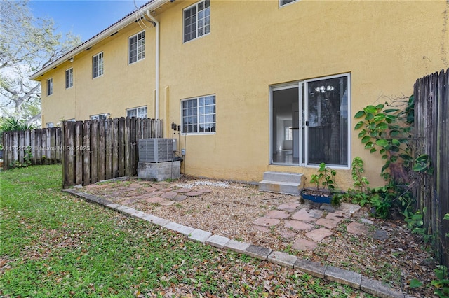 330 SW 2nd Ave Unit 3, Hallandale Beach, FL 33009 - rear view of house with fence, entry steps, and stucco siding