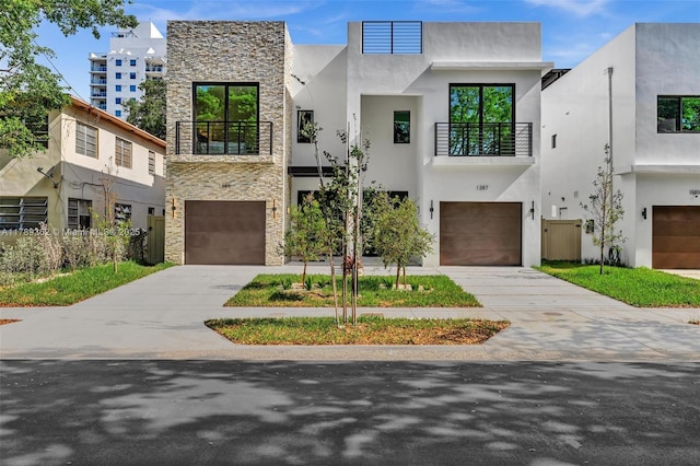 1389 SW 22nd Ter, Miami, FL 33145 - contemporary house with an attached garage, a balcony, and stone siding