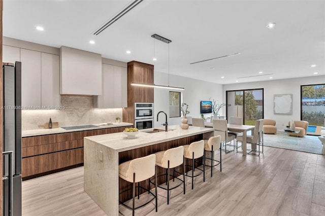 1389 SW 22nd Ter, Miami, FL 33145 - kitchen featuring appliances with stainless steel finishes, a sink, light countertops, light wood-type flooring, and modern cabinets