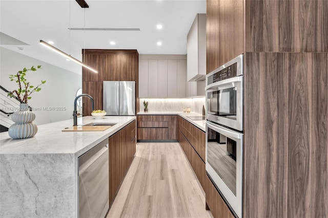 1389 SW 22nd Ter, Miami, FL 33145 - kitchen with a sink, light wood finished floors, brown cabinetry, stainless steel appliances, and modern cabinets