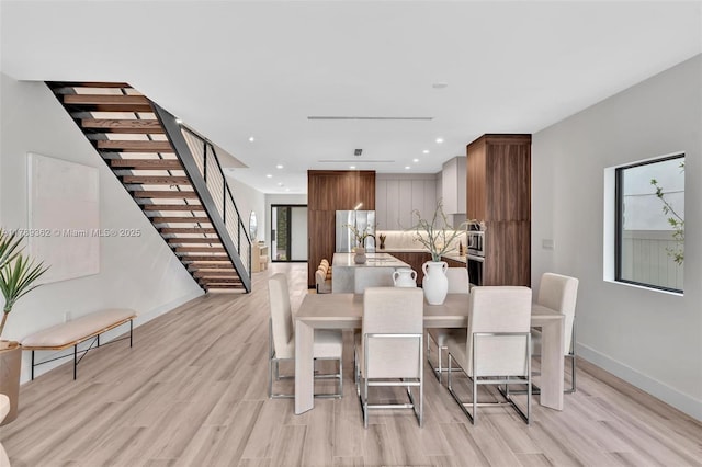 1389 SW 22nd Ter, Miami, FL 33145 - dining room with light wood-type flooring, baseboards, and stairway