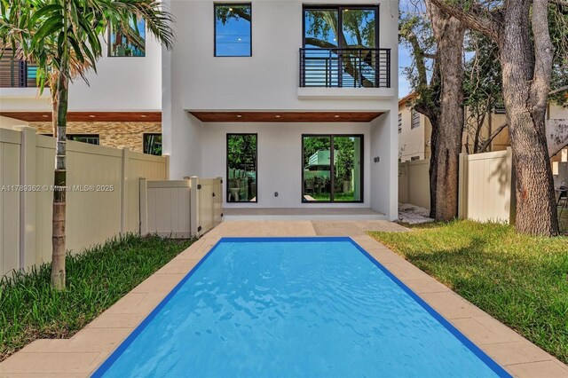1389 SW 22nd Ter, Miami, FL 33145 - back of property featuring a fenced in pool, stucco siding, a patio, and fence