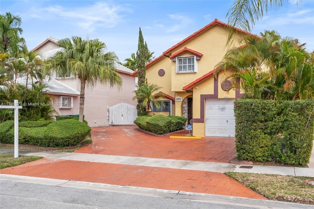 5933 SW 151st Pl, Miami, FL 33193 - view of front facade featuring decorative driveway, stucco siding, a gate, and a garage