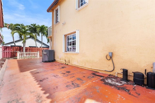 5933 SW 151st Pl, Miami, FL 33193 - view of side of property with cooling unit, stucco siding, and a patio