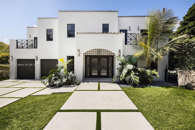 120 Morningside Dr, Coral Gables, FL 33133 - view of front of home featuring a front yard, stucco siding, french doors, concrete driveway, and an attached garage