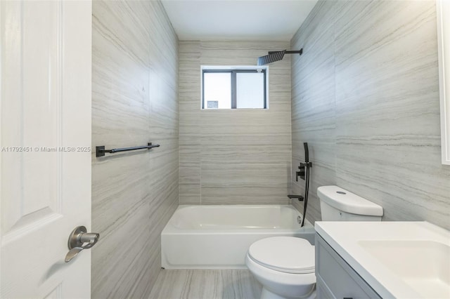 bathroom featuring toilet,  shower combination, tile walls, and vanity