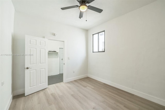 unfurnished bedroom with light wood-style floors, baseboards, and a ceiling fan