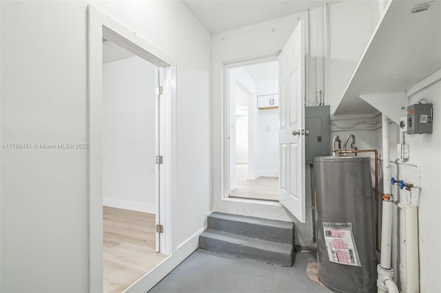 corridor featuring water heater and electric panel
