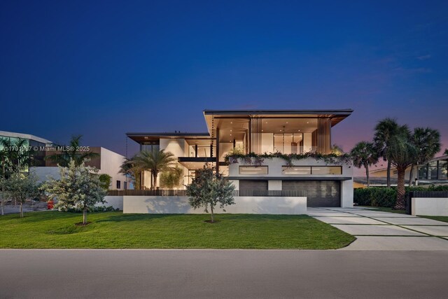 11404 N Bayshore Dr, North Miami, FL 33181 - modern home featuring driveway, a balcony, stucco siding, and an attached garage
