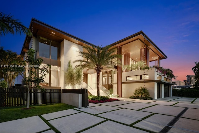 11404 N Bayshore Dr, North Miami, FL 33181 - modern home featuring concrete driveway, stucco siding, an attached garage, and a balcony