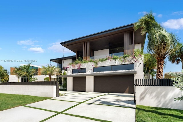 11404 N Bayshore Dr, North Miami, FL 33181 - contemporary home with a balcony, stucco siding, driveway, and an attached garage