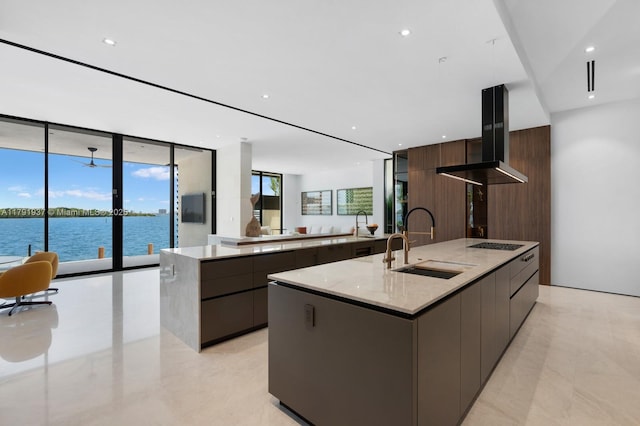 11404 N Bayshore Dr, North Miami, FL 33181 - kitchen featuring modern cabinets, a sink, a spacious island, cooktop, and recessed lighting