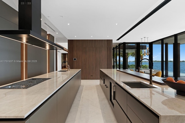 11404 N Bayshore Dr, North Miami, FL 33181 - kitchen with modern cabinets, a large island, a sink, a water view, and recessed lighting