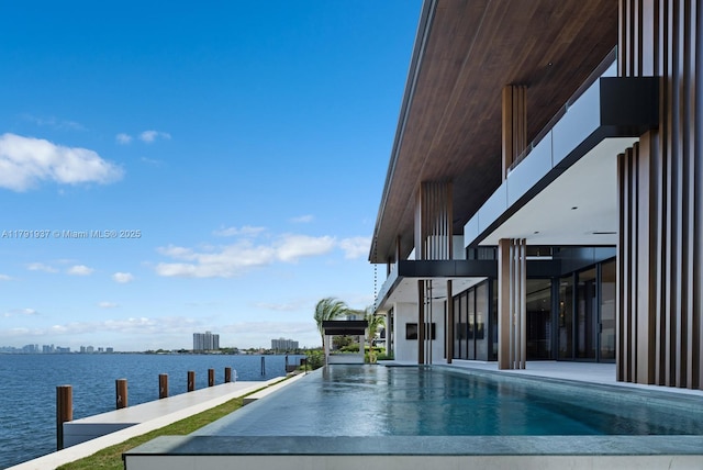 11404 N Bayshore Dr, North Miami, FL 33181 - view of swimming pool with a water view and an infinity pool